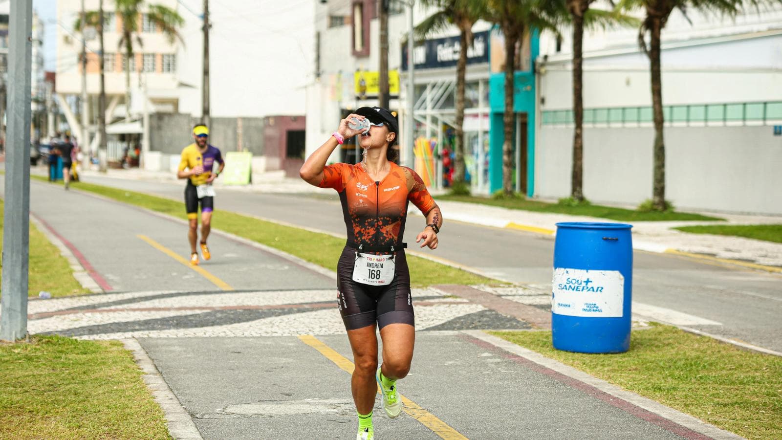 triathlete consuming energy gels and hydration during ironman race to maintain endurance and performance