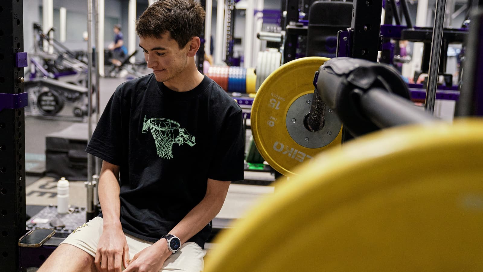 Alex Yee in the gym during a strength training session, focusing on exercises to improve power, stability, and triathlon performance.