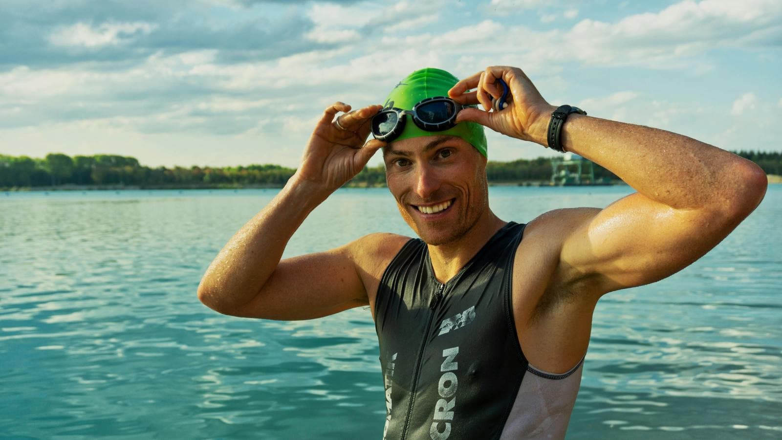 open water swimmer wearing wetsuit swimming in lake choosing right wetsuit for performance and warmth