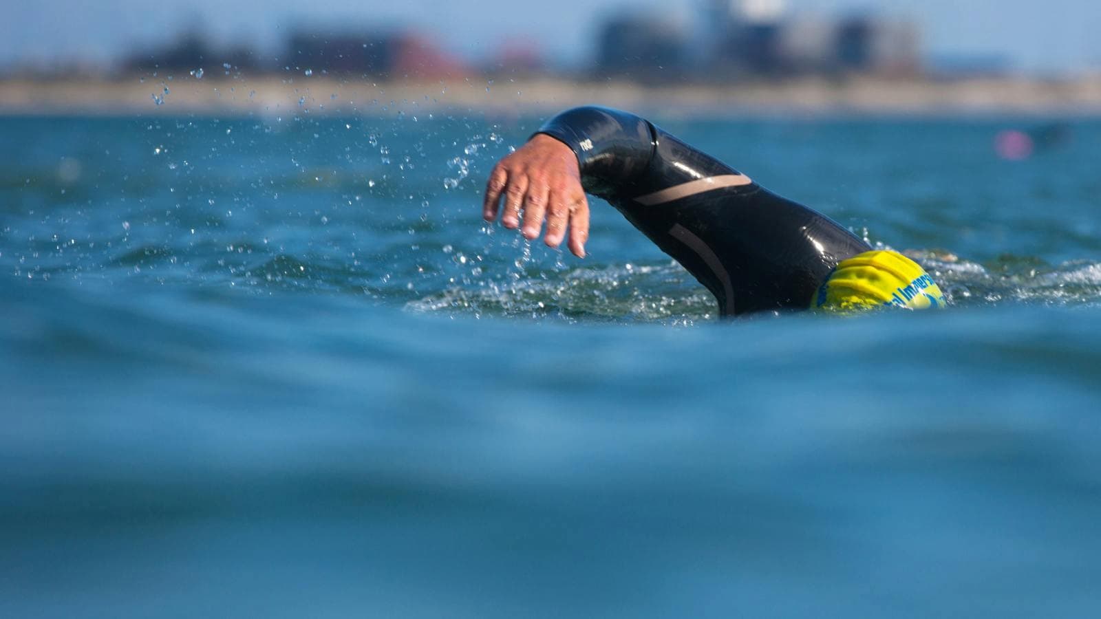 swimmer completing endurance laps in pool during off season swim training workout