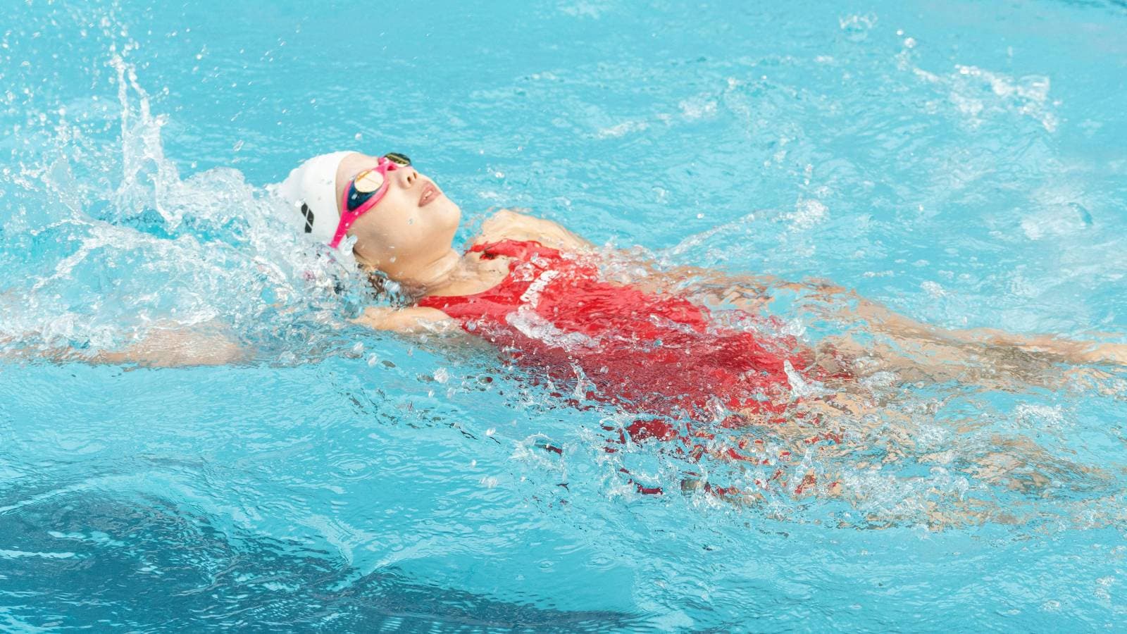 swimmer practicing smooth freestyle stroke technique to improve swimming efficiency and performance