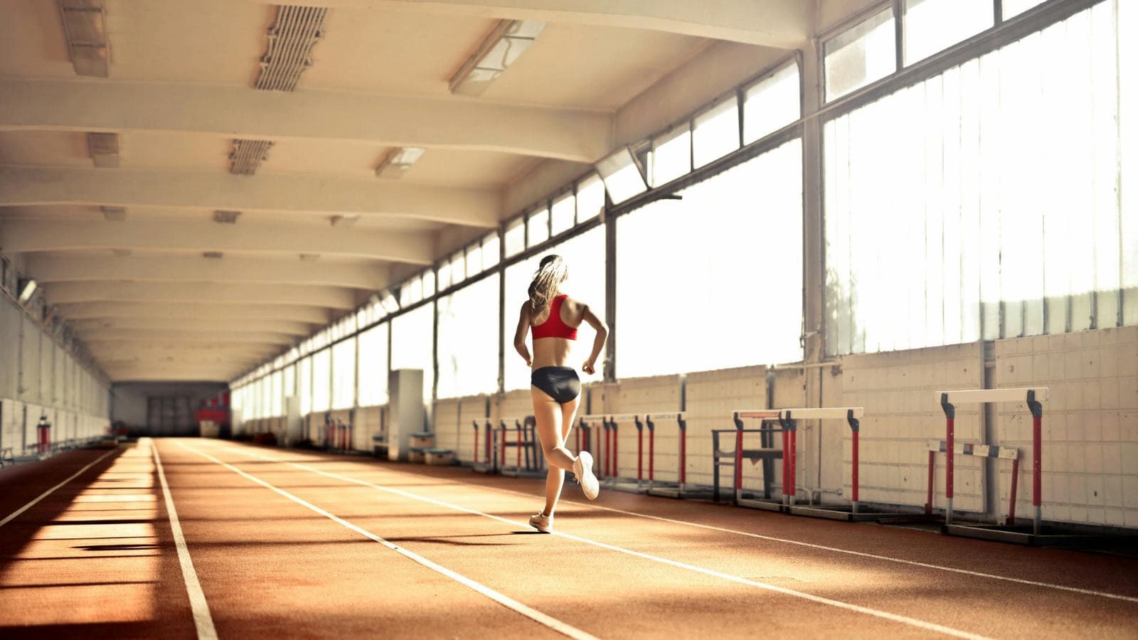 triathlete training indoors on bike trainer and treadmill preparing for ironman triathlon