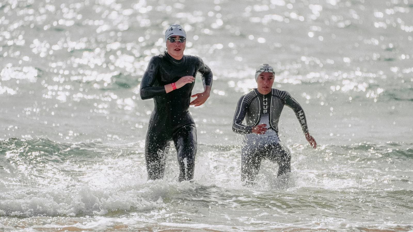 open water swimmer entering cold water slowly to build tolerance and acclimate for winter swimming