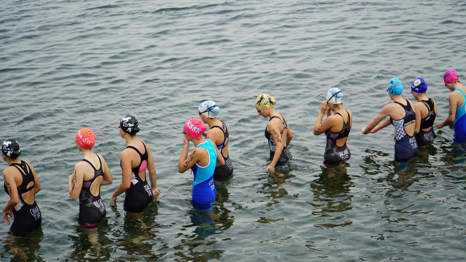 triathlete training in both pool and open water to prepare for upcoming swim event