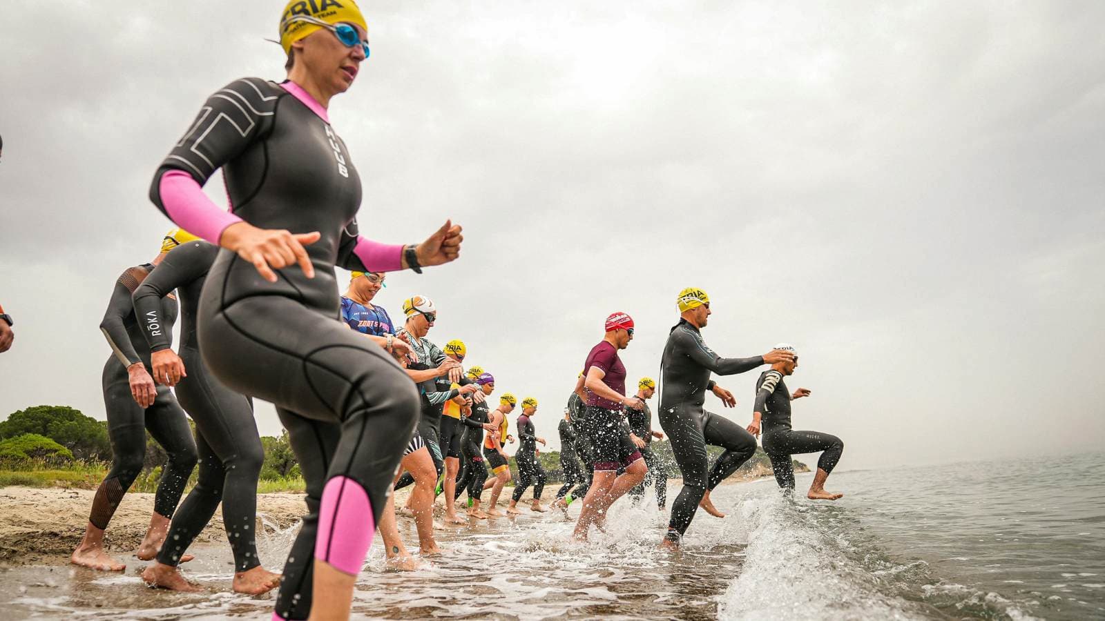 Swimmer training in open water with waves and natural conditions preparing for triathlon