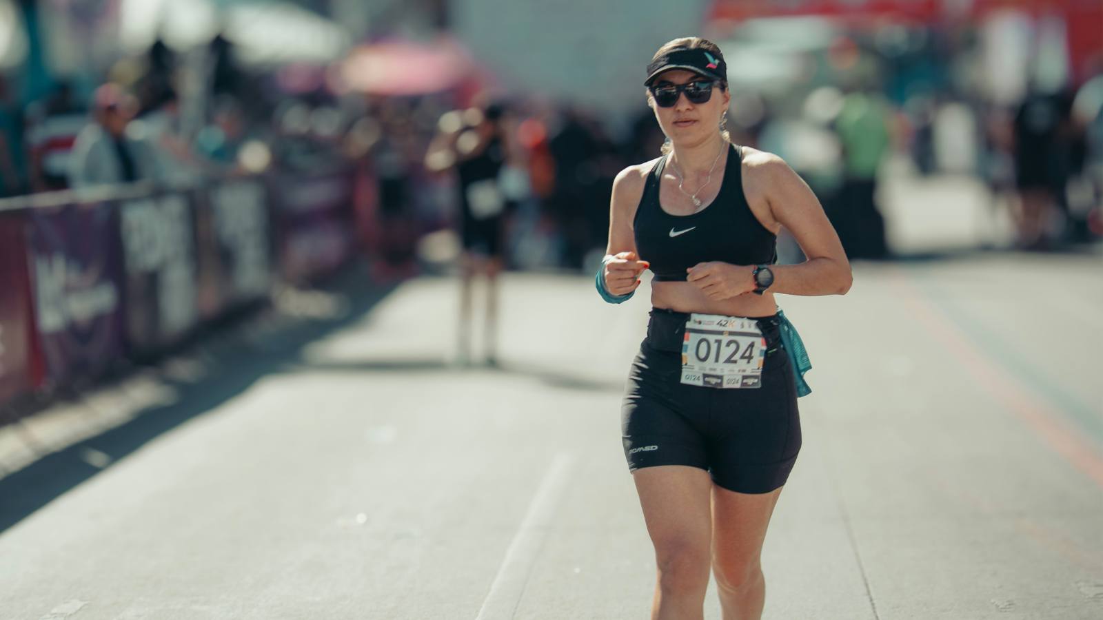 Athlete training for an Ironman triathlon by swimming, cycling, and running in sequence, showcasing endurance preparation and fitness progression
