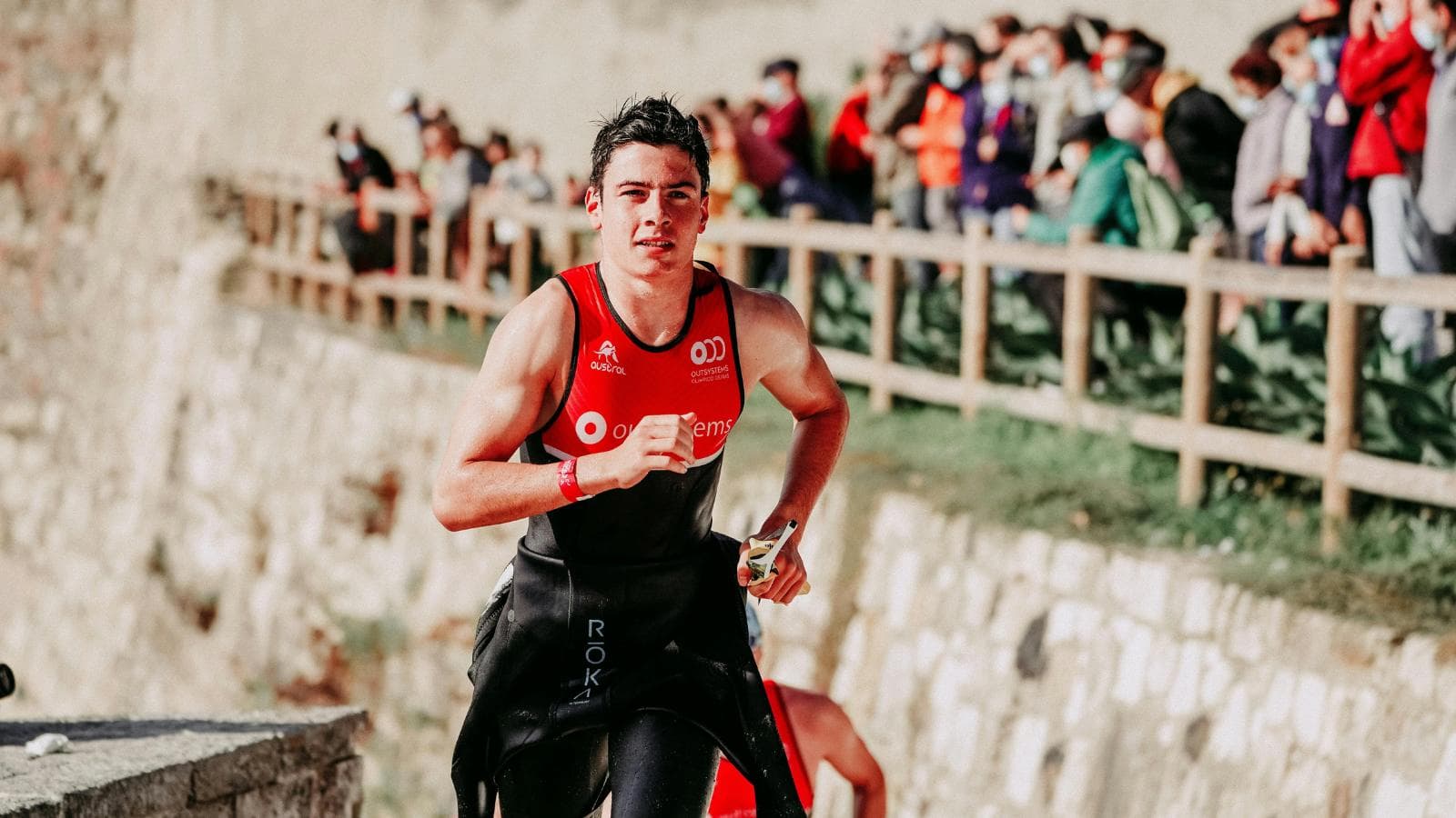 triathlete running strongly after swim and bike segments while managing fatigue effectively