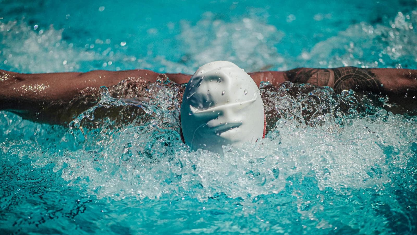 athlete following structured endurance swim workout in pool during triathlon off season