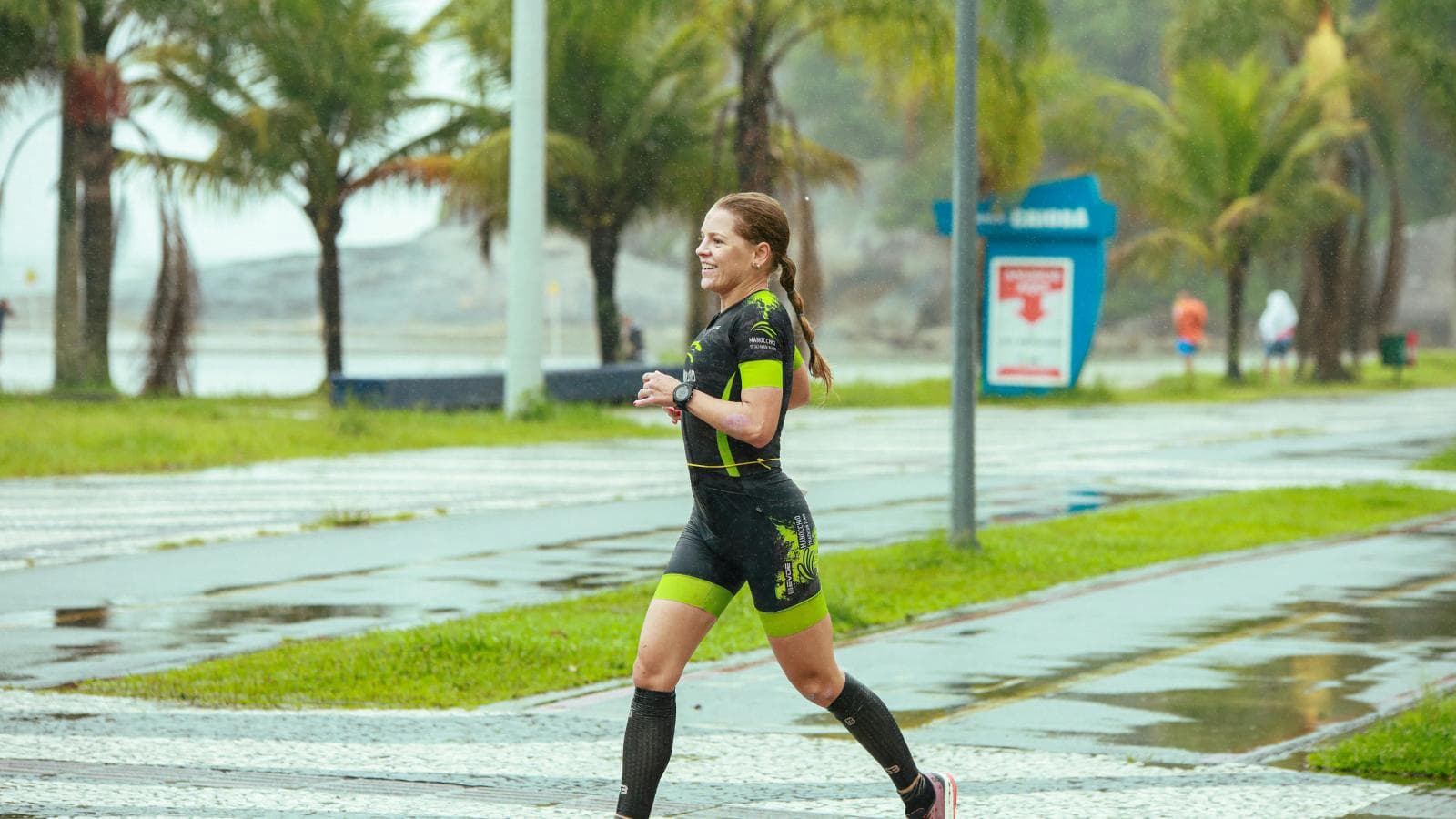 triathlete adapting to rain and wind during triathlon race with proper gear and pacing strategy
