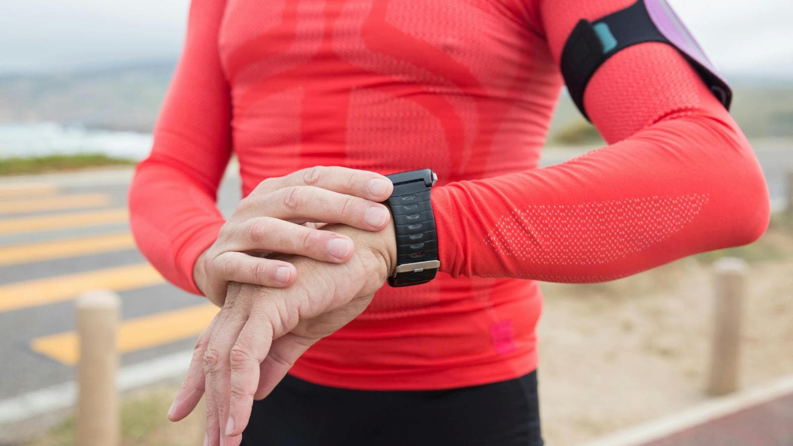 triathlete checking glucose monitoring data to optimize training performance and recovery