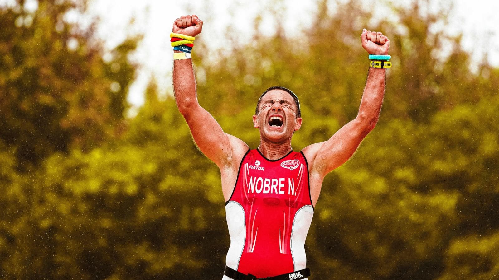 beginner triathlete running toward finish line after managing pacing and nutrition strategy well