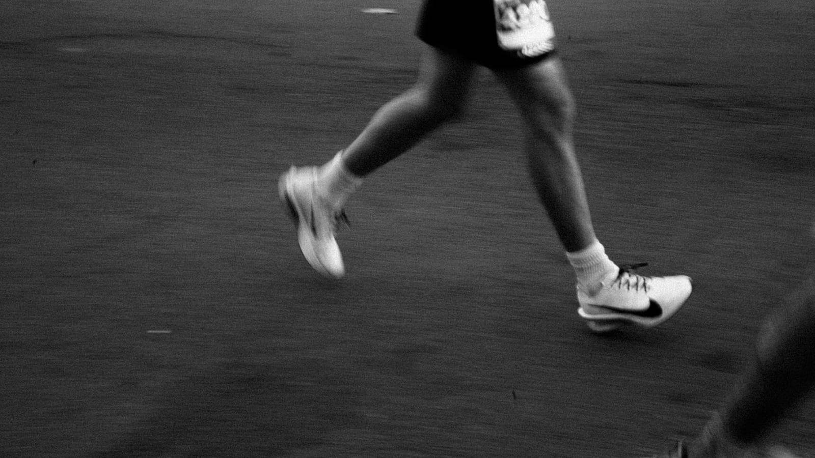 triathlete running with efficient technique and strong posture during triathlon race