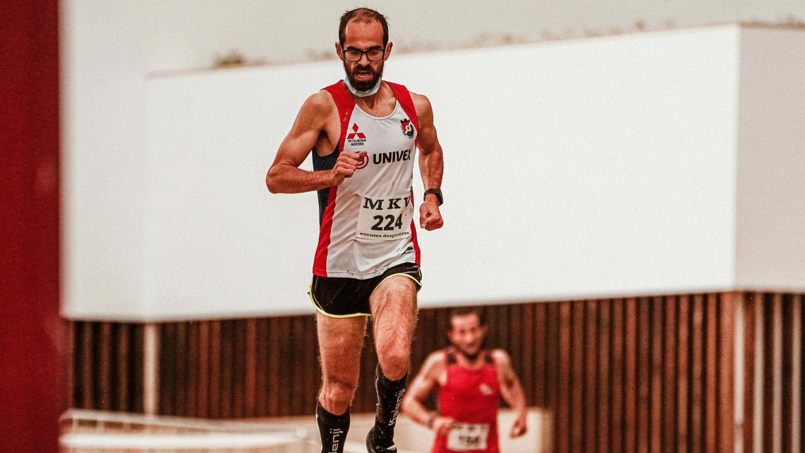beginner triathlete crossing finish line after completing first triathlon race