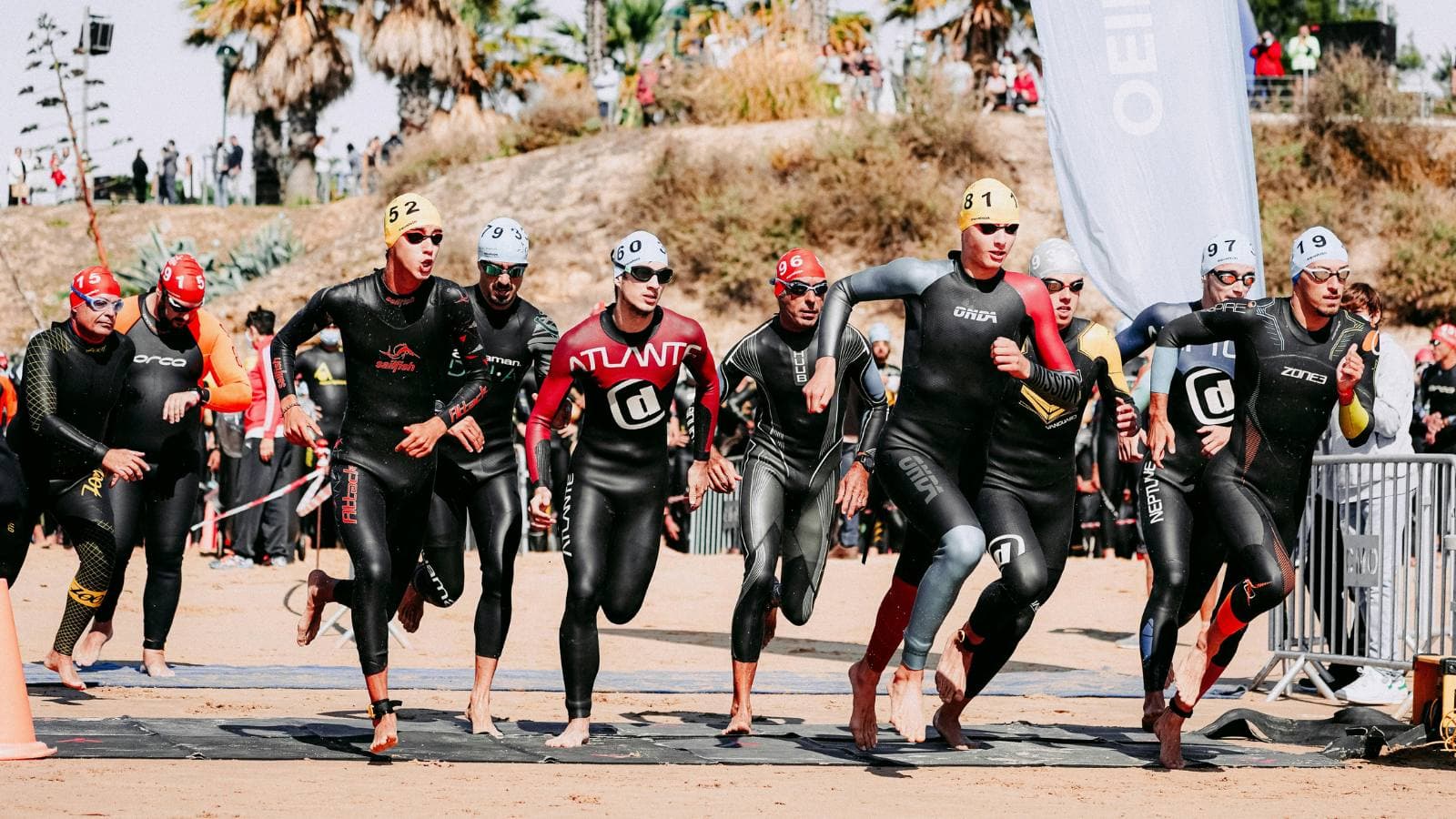triathlete entering transition zone after open water swim with organized race gear setup
