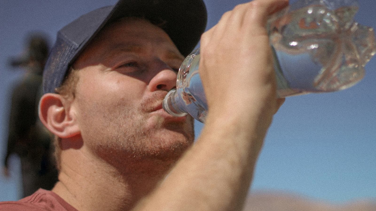 triathlete recovering with hydration and nutrition after completing triathlon competition