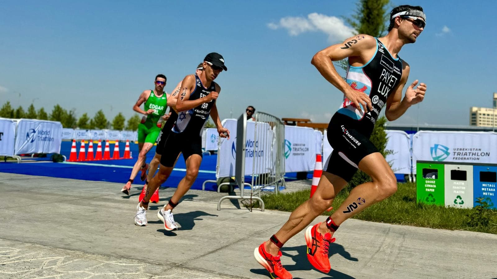 group of triathletes training together during swim bike and run workout session