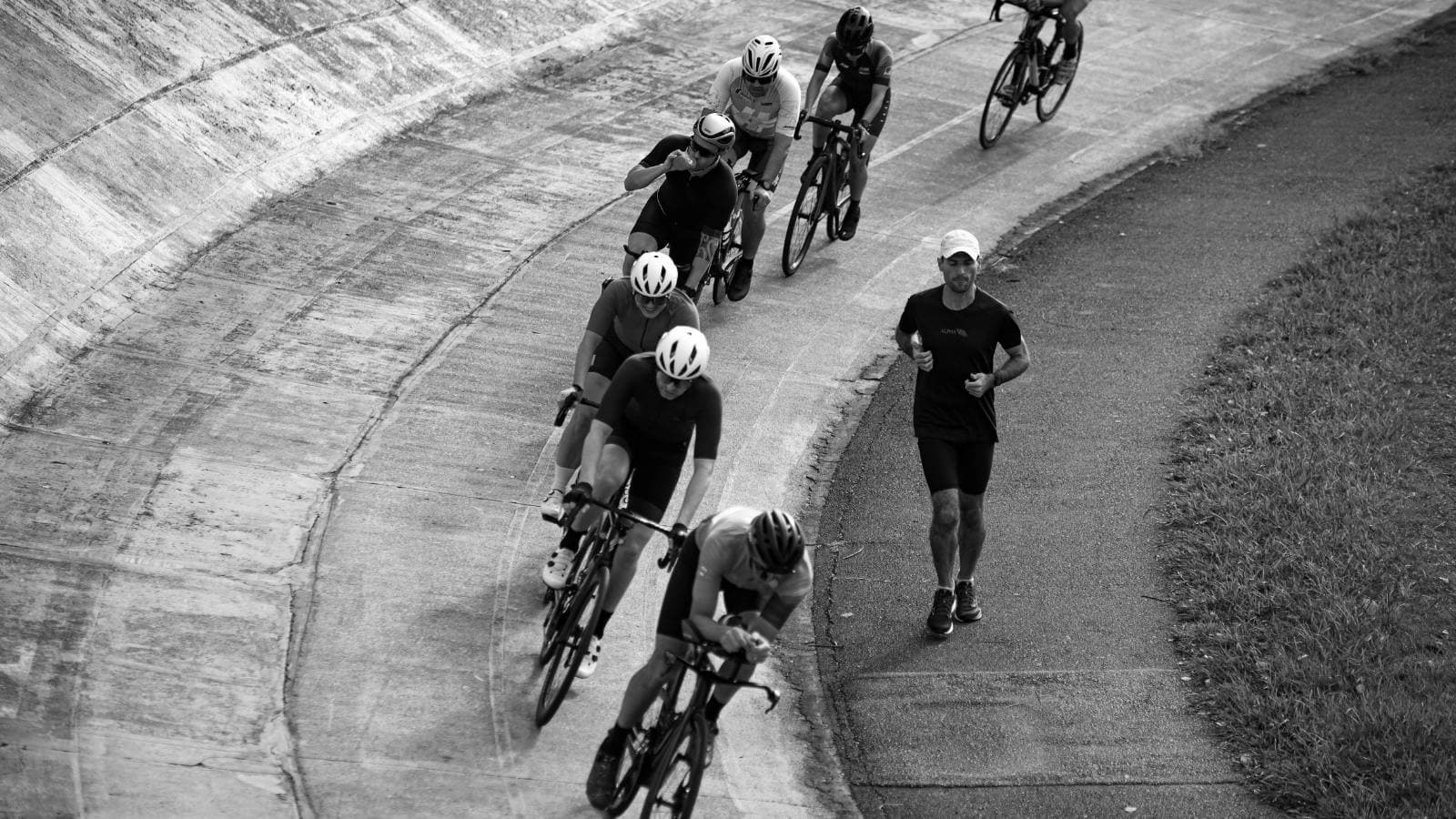 road cyclist leaning into corner with correct body position and controlled braking technique