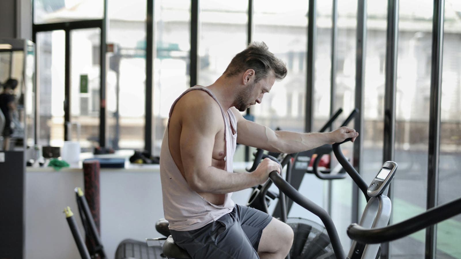 triathlete stretching and doing light recovery exercises after intense triathlon event
