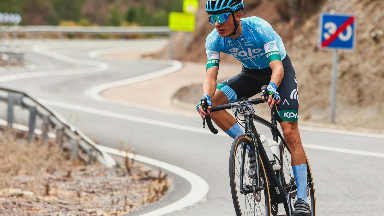 triathlete climbing hill on bike maintaining steady effort during triathlon race
