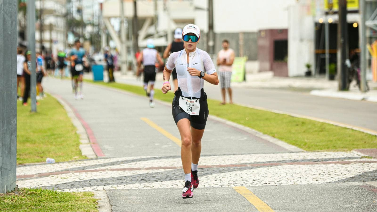 triathlete competing in swim bike and run stages with structured pacing strategy during race