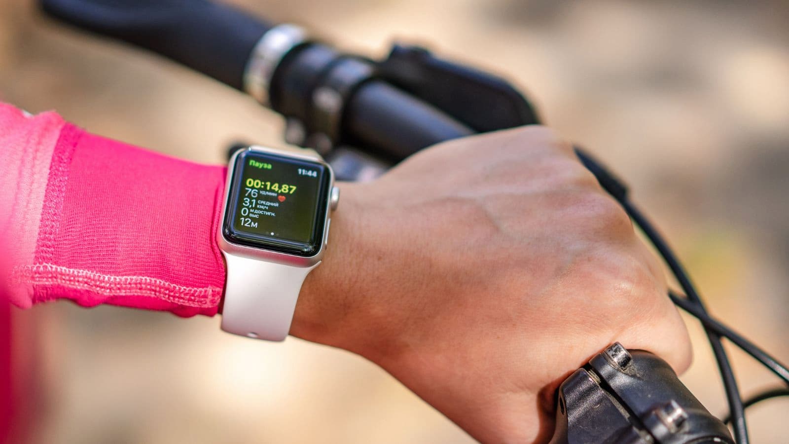 triathlete analyzing training data on smartwatch and bike computer during endurance training session
