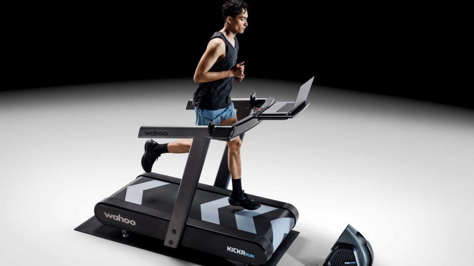 athlete comparing treadmill workout data with smartwatch metrics during triathlon training