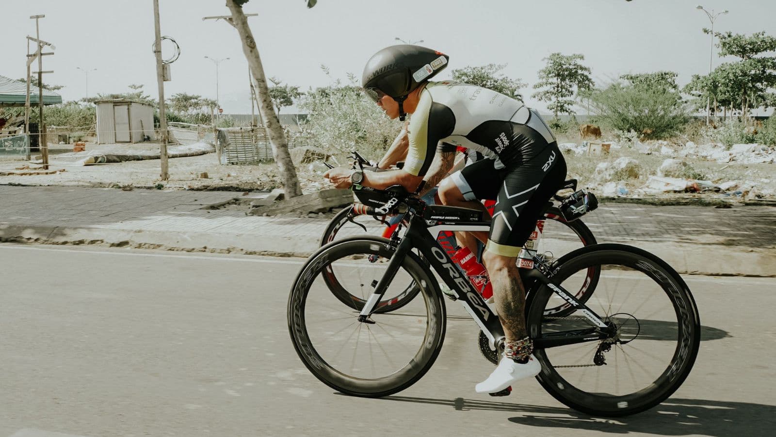 triathlete performing cycling drill to improve bike handling skills and pedaling technique