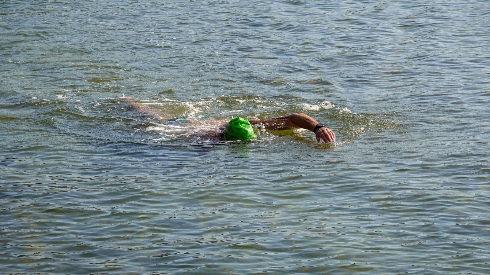 triathlete practicing freestyle swimming technique drills to prepare for upcoming triathlon season
