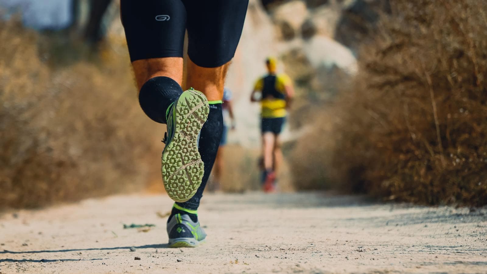 triathlete stretching lower legs and calves to prevent and treat shin splints during training