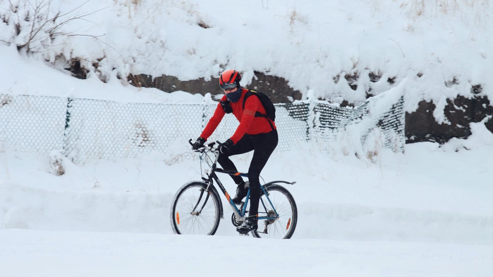 triathlete cycling in winter conditions to improve bike handling skills and riding confidence