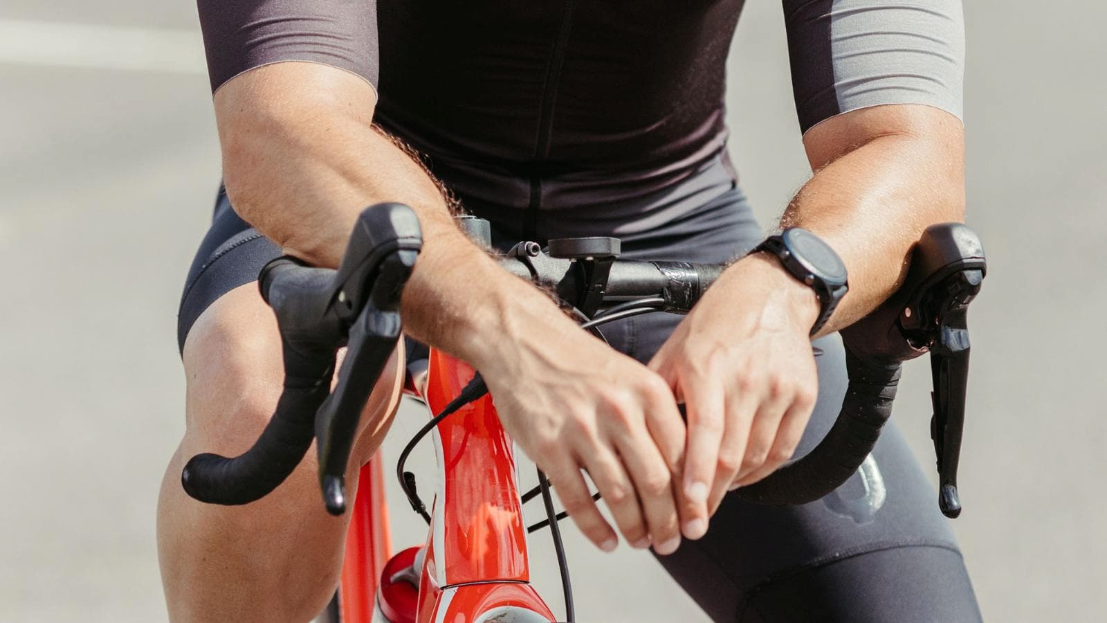 cyclist shaking out hands during ride to relieve numbness caused by carpal tunnel syndrome