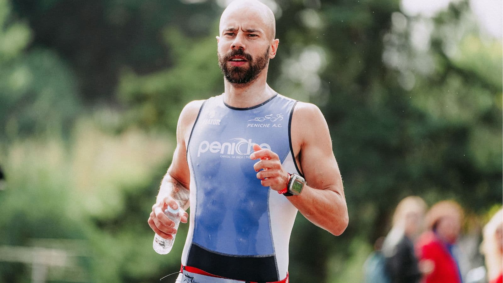 triathlete consuming recovery nutrition with carbohydrates after swim bike and run event