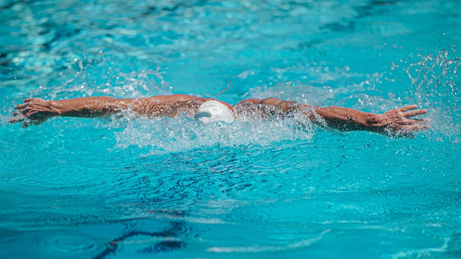 triathlete practicing open water swimming before race to build confidence and improve technique