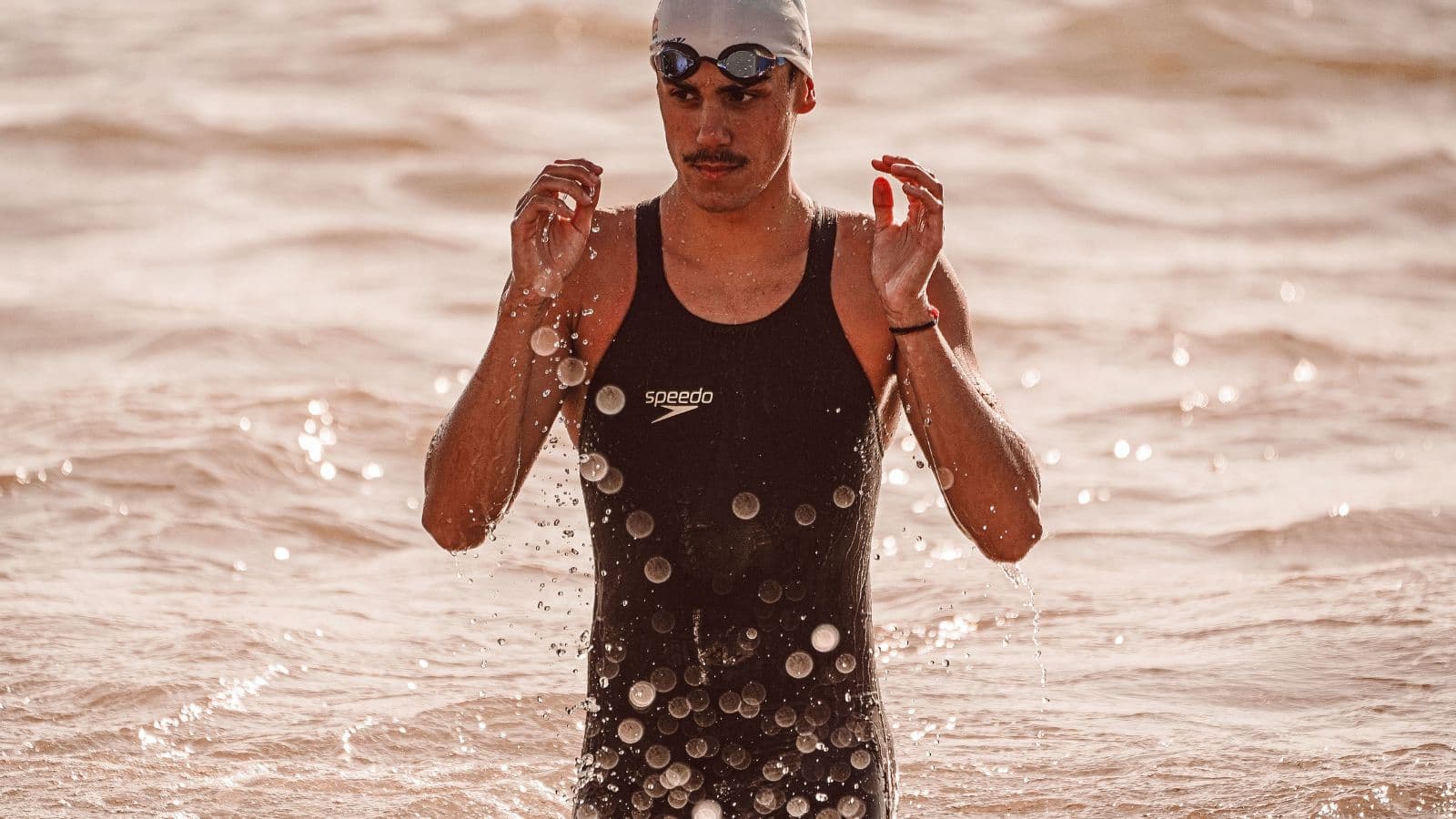 triathlete swimming freestyle with sinking legs affecting body position and swimming efficiency
