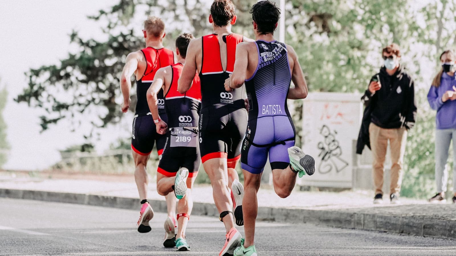 elite triathlete training across swimming cycling and running to prepare for Olympic distance competition