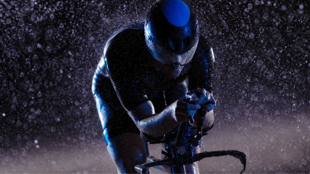 Road bike equipped with front and rear lights and reflective accessories for safer cycling in rainy, low-visibility conditions.