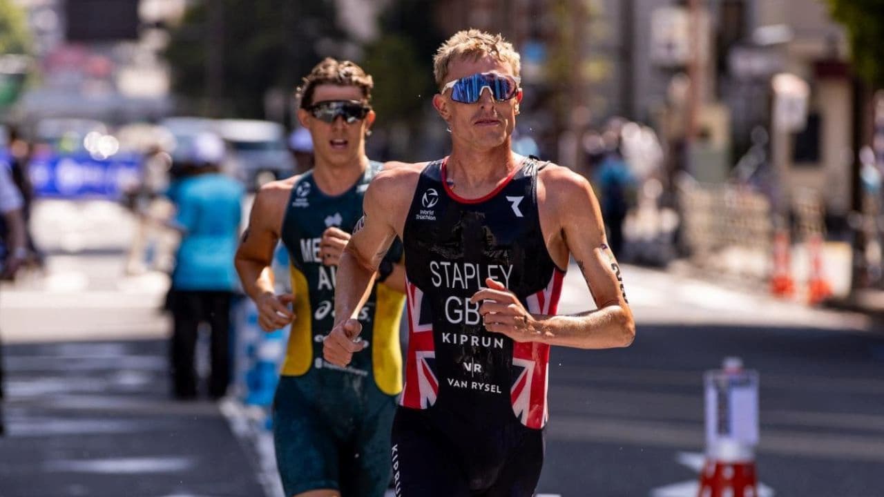 Triathlete running with a relaxed and efficient arm swing to improve running form, balance, and overall performance.