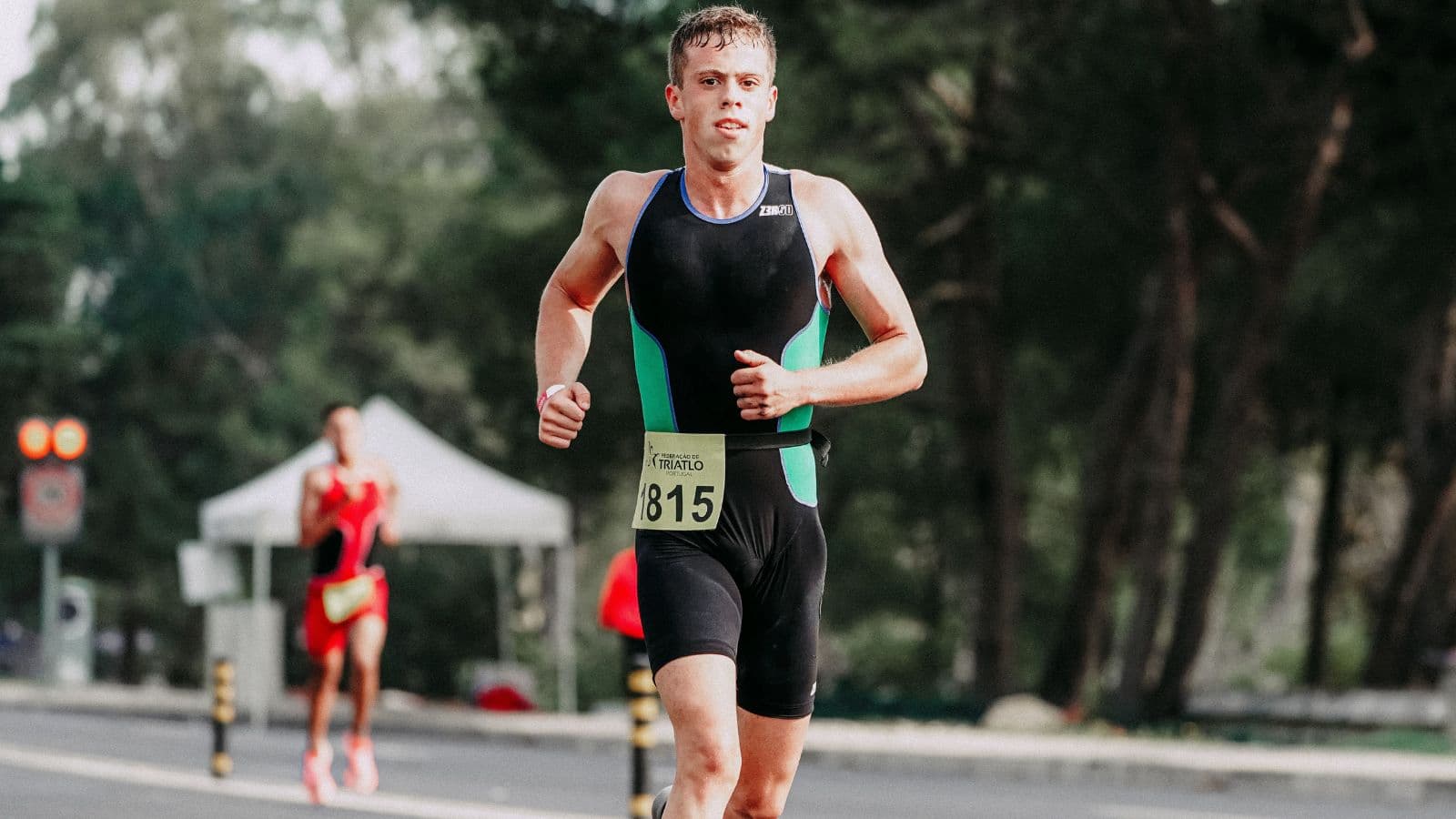 Runner maintaining a strong, controlled pace during a tempo run on a paved road