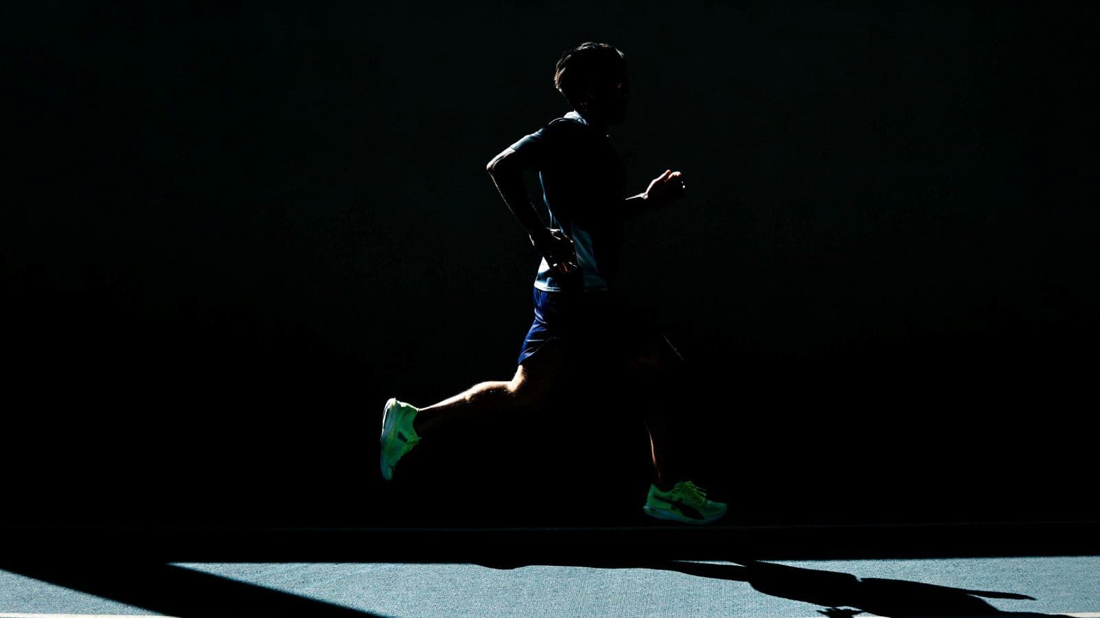Triathlete running with a quick, light stride focusing on natural cadence rhythm
