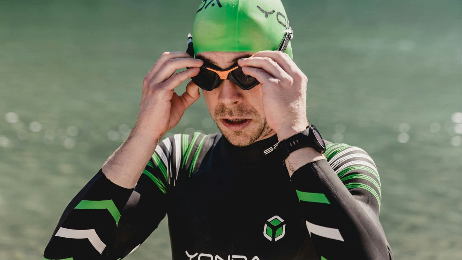 triathlete practicing deep breathing and mental preparation before open water swim start