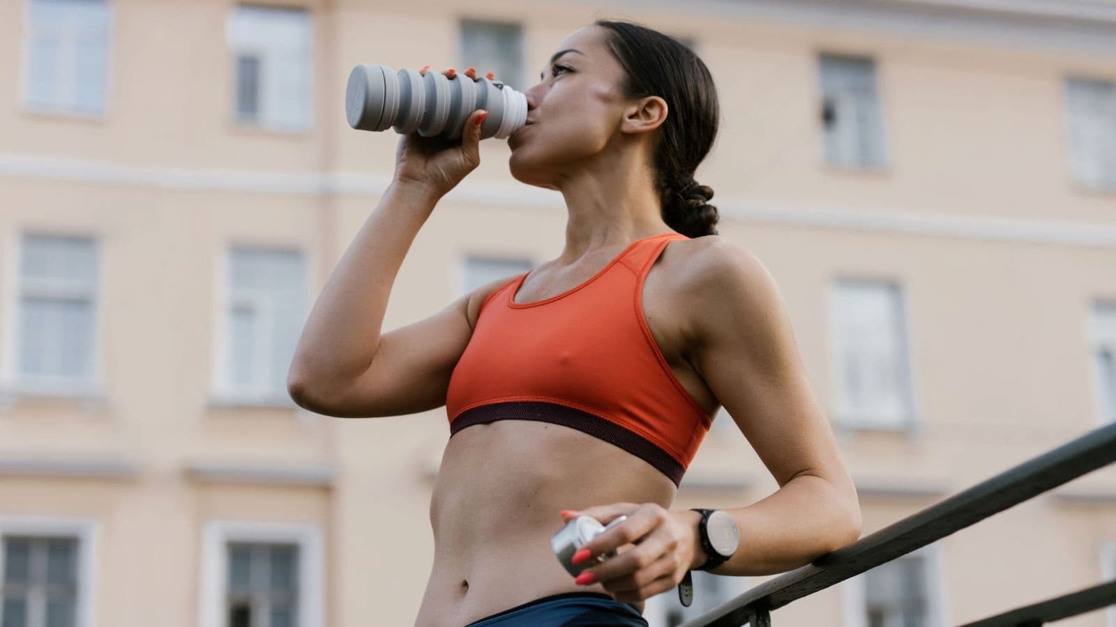Triathlete drinking calcium rich protein shake post triathlon race for recovery