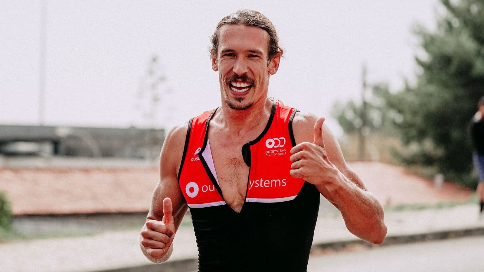 Triathlete checking pace on a smartwatch while running faster than intended Zone 2 effort
