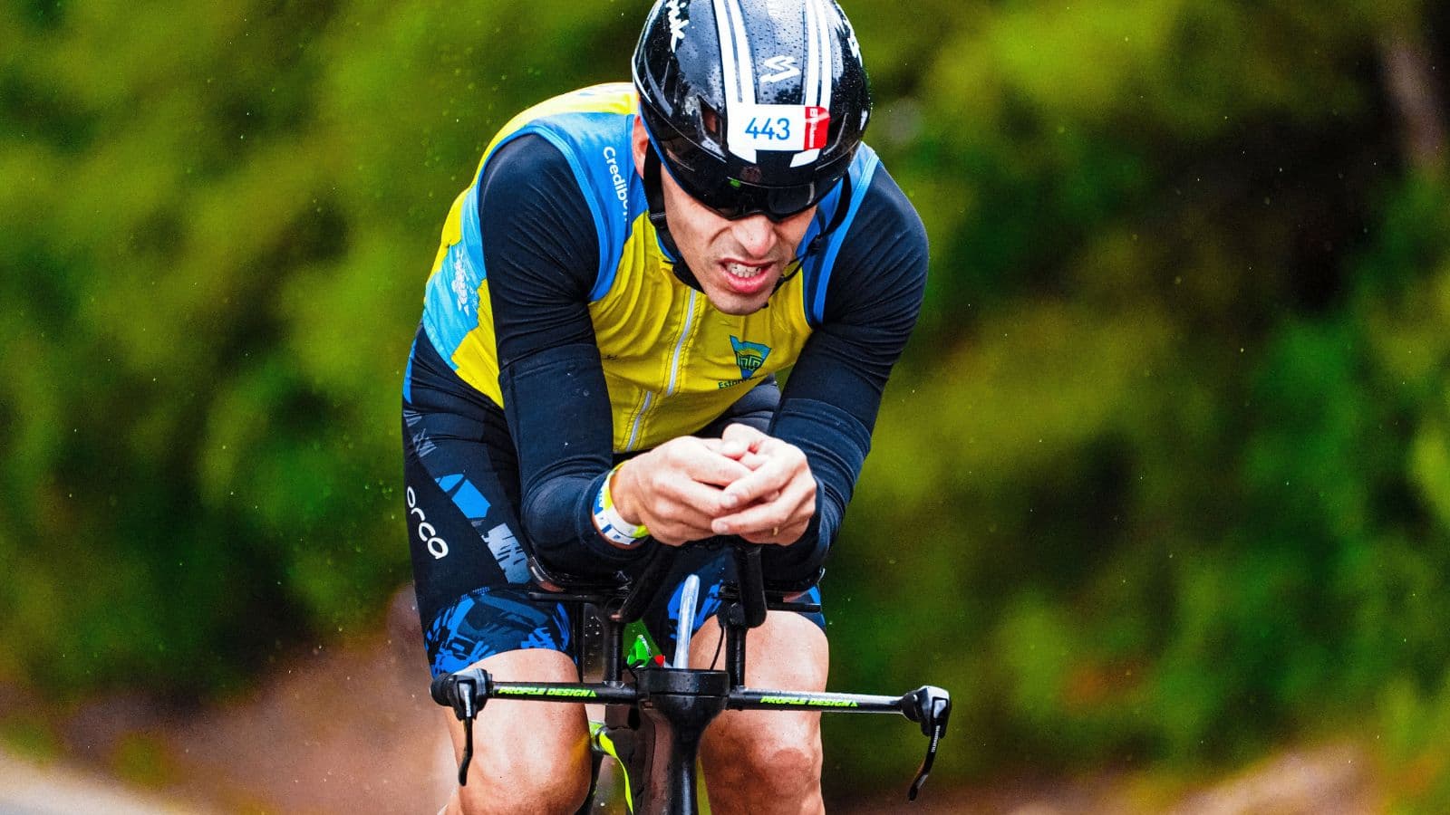Triathlete pedaling at a high cadence on a road bike to conserve leg strength for the run