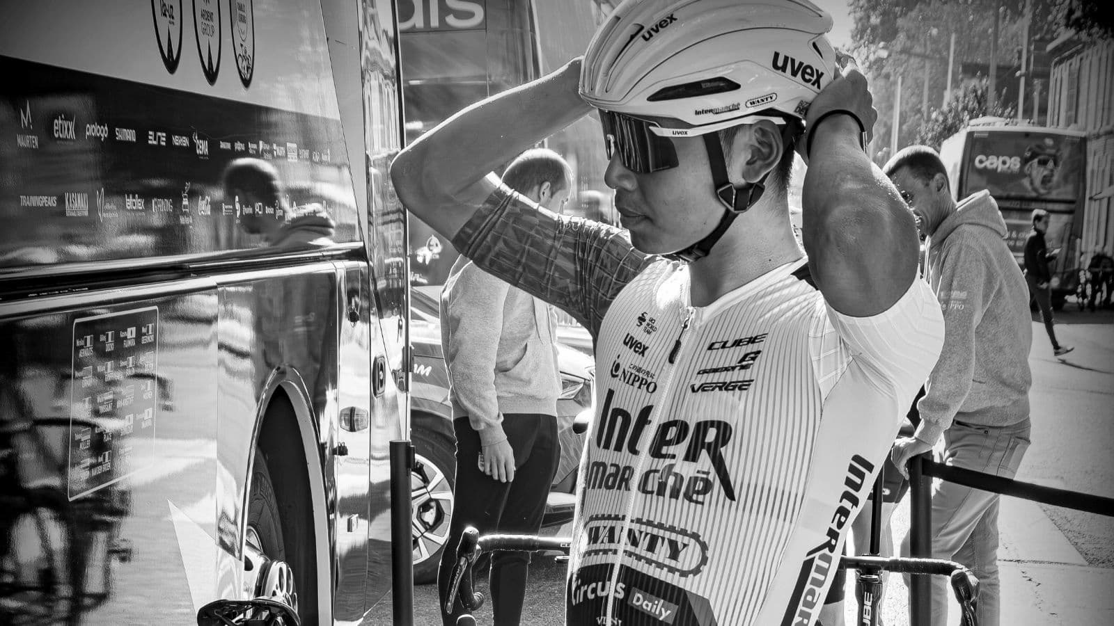 Triathlete standing beside their bike with eyes closed while mentally rehearsing a successful triathlon race.