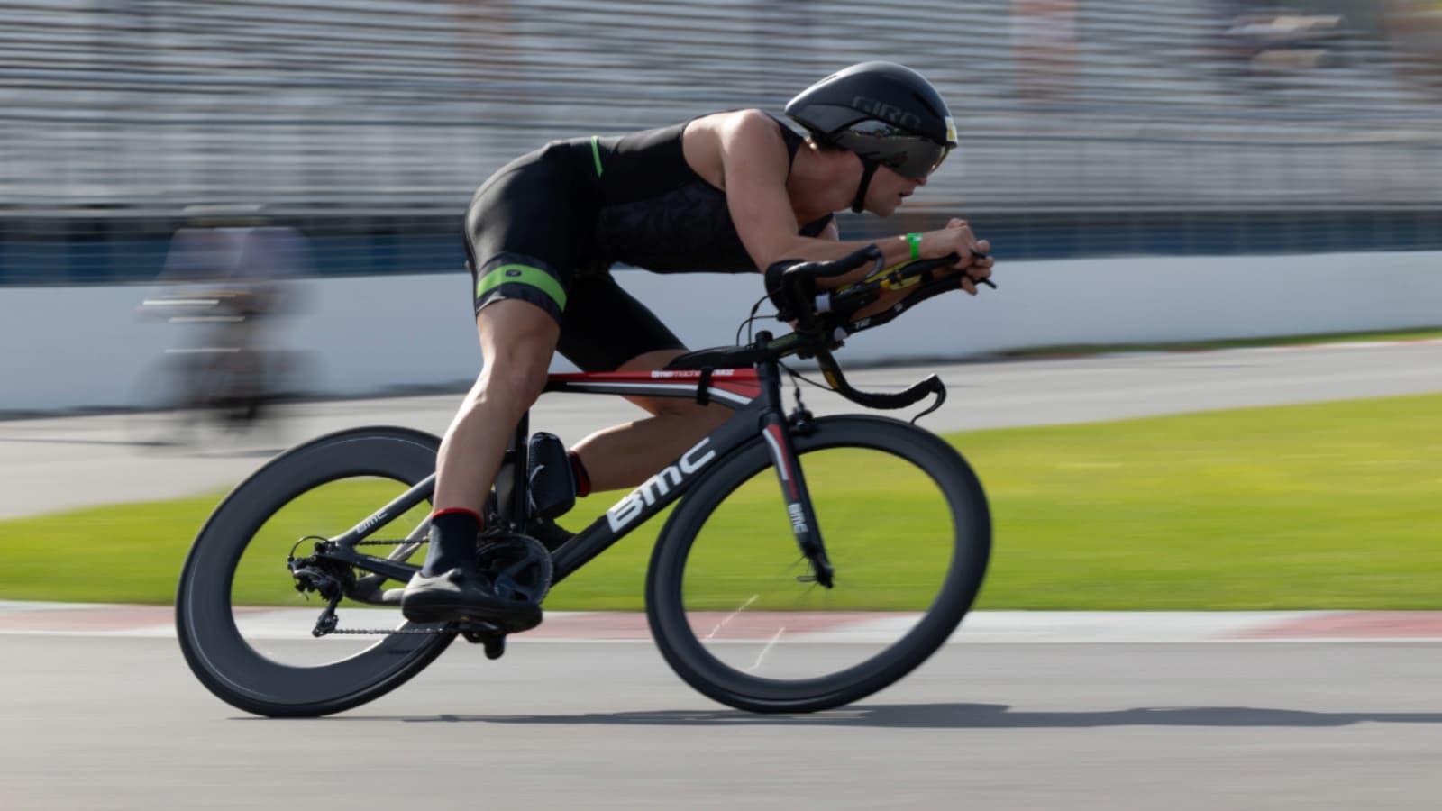 Cyclist squeezing road bike brake levers to check brake performance and safety before heading out on a ride.