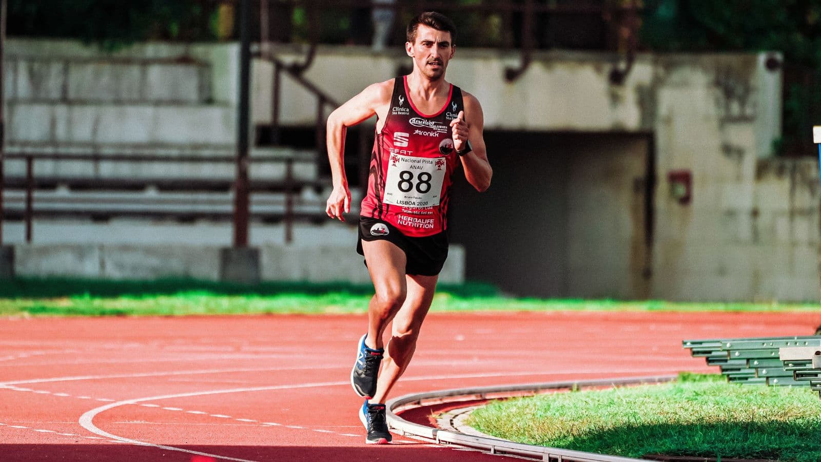Triathlete running at a relaxed, conversational pace along a trail during aerobic base training