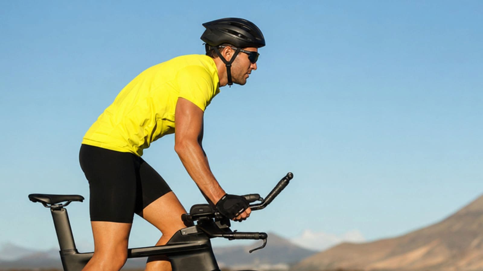 Cyclist standing on the pedals while climbing a steep section of road