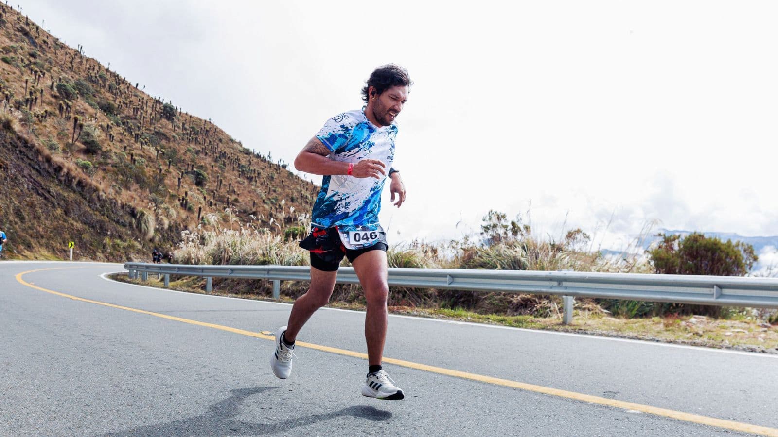 Triathlete running uphill during hill training to build leg strength, cardiovascular fitness, and endurance for triathlon racing.