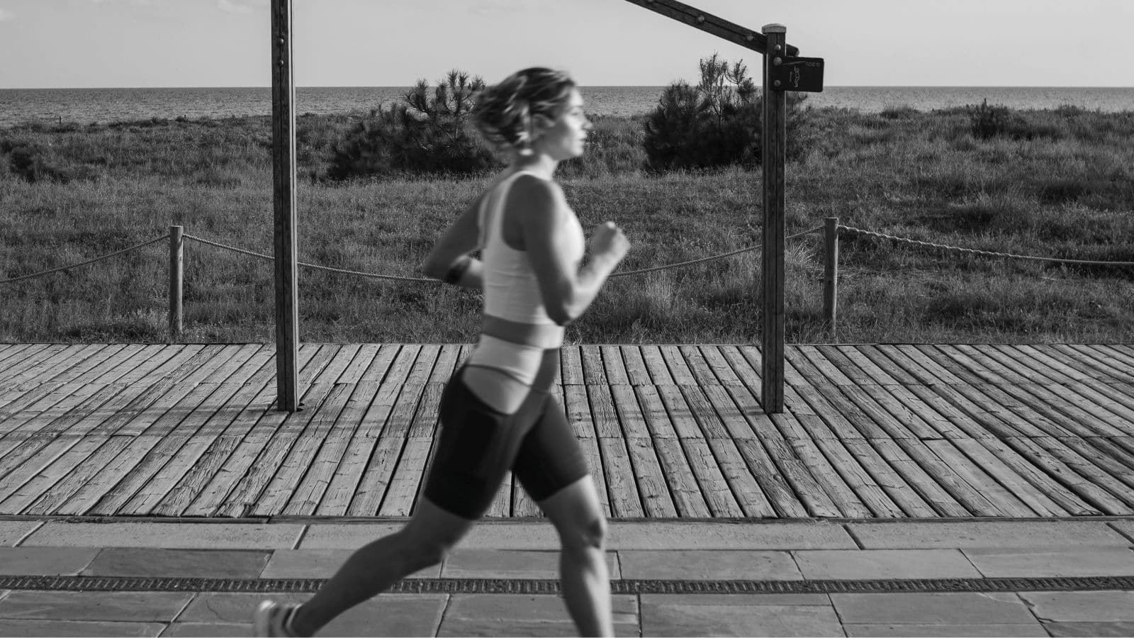 Triathlete stretching hips immediately after finishing the cycling leg before starting the run