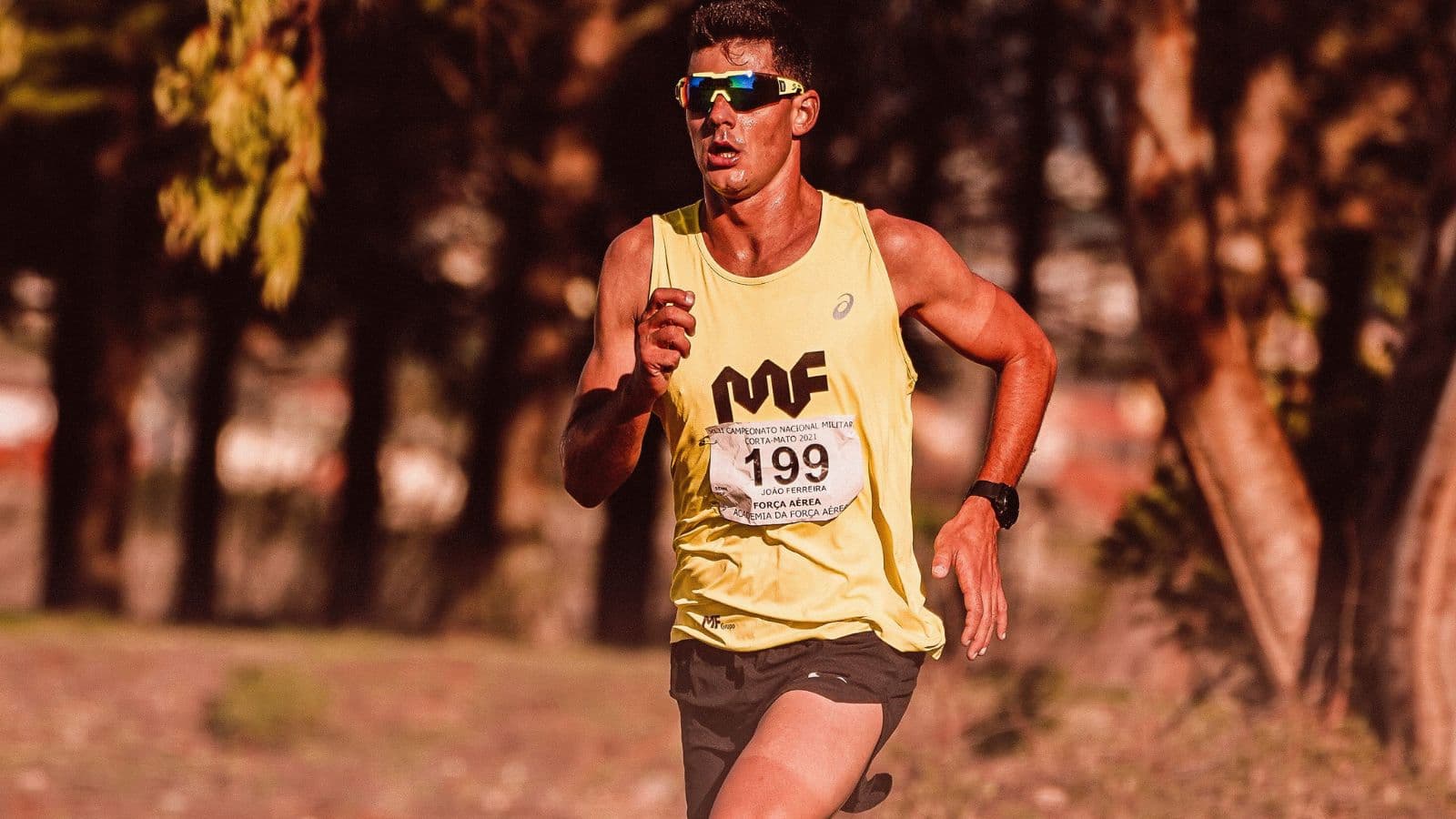 Triathlete running with efficient form and relaxed posture to improve running economy and race performance.